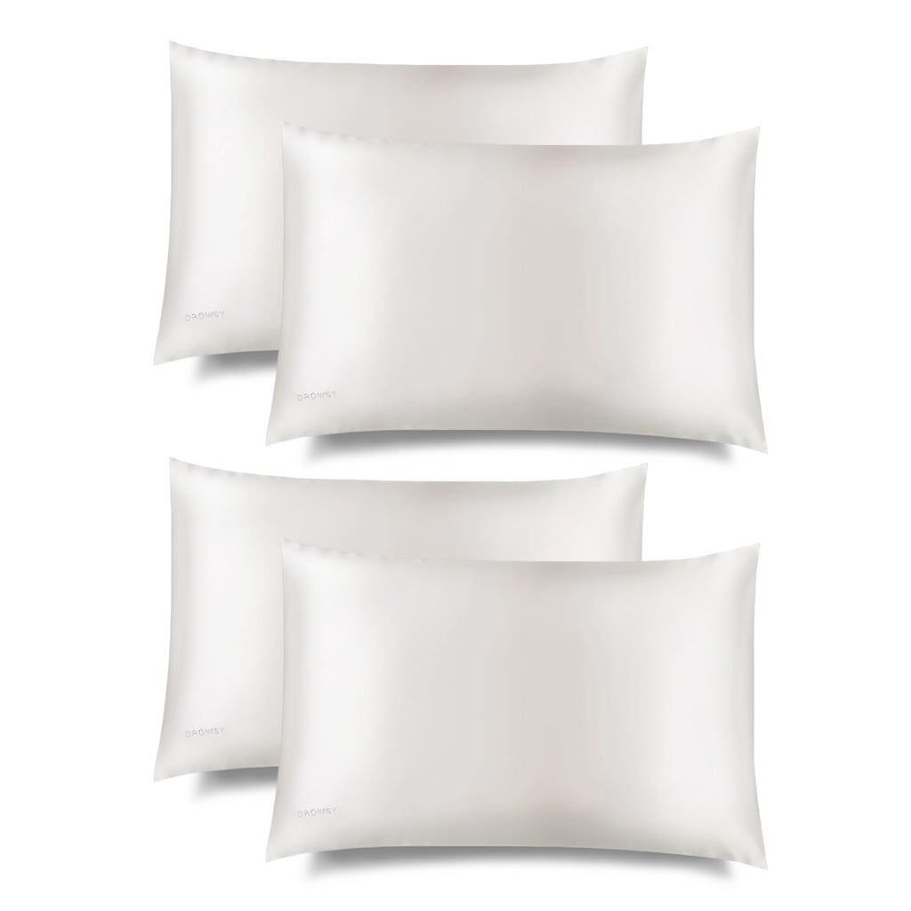 Four Akoya Pearl Silk Pillowcases feature a sleek white rectangular design with a subtle embroidered DROWSY logo in the lower left corner, displayed on a white background with a soft right shadow—an essential for hair protection and skincare.