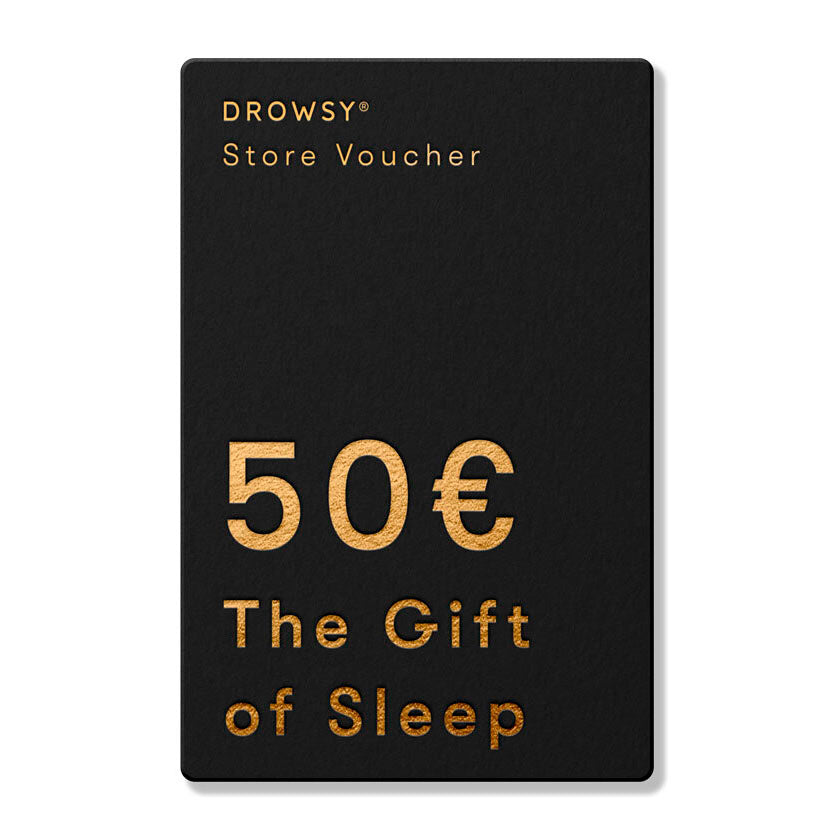 A black rectangular Sleep Gift Card with gold text: "DROWSY Store Voucher, 50€, The Gift of Sleep"—ideal for gifting restful nights from our online store.