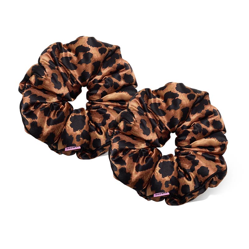 Two Hotel Paradiso - Wild Thing Padded Scrunchies in brown and black leopard print silk sit side by side on a white background, offering hair-thickening benefits with a touch of style.