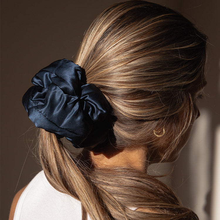 Lifestyle image of a girl wearing a drowsy Midnight Blue pillow scrunchie