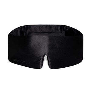 The Black Jade eye mask features a black contoured silk design with padding for ultimate comfort and DROWSY embossed on one side—a perfect choice for blackout and beauty sleep.