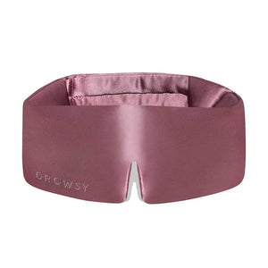 The Damask Rose is a wide, silky pink sleep mask featuring a central nose cutout and DROWSY embossed on the front left. This soft, padded silk mask ensures total darkness for uninterrupted beauty sleep.