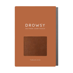 A rectangular orange-brown package labeled PUMPKIN SPICE SILK CARRY POUCH features a window displaying the mulberry silk pouch inside; TUSCAN KISS is printed at the bottom.