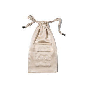 The Dusty Gold Silk Carry Pouch features a small front pocket with DROWSY subtly embossed, perfect for storing your silk sleep mask. Presented against a white background.