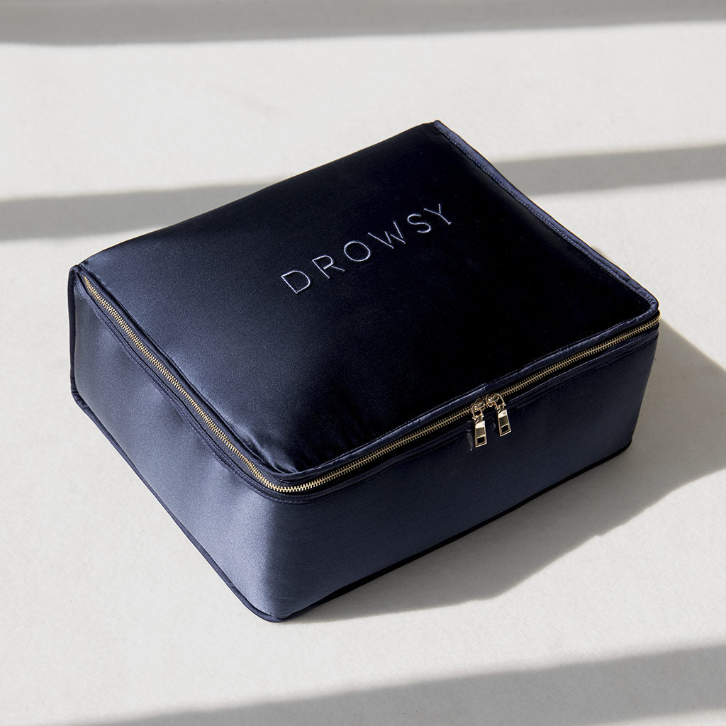 A rectangular, navy blue zippered pouch with "DROWSY" printed on top—ideal for storing your Midnight Blue Silk Weighted Blanket and ensuring deep relaxation wherever you go.