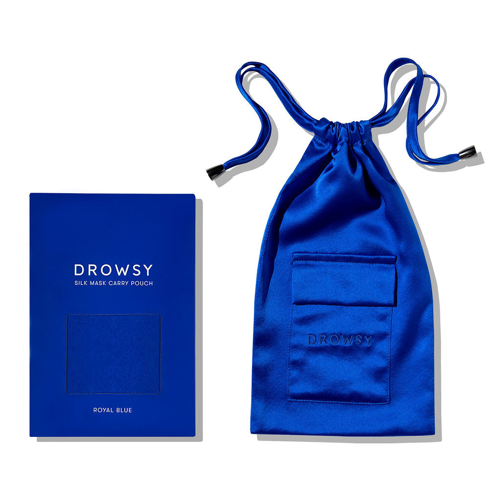 The Royal Blue Silk Carry Pouch features a minimalist design, textured mulberry silk fabric, and a secure drawstring closure. Shown with its matching rectangular box packaging, it's perfect for storing your silk sleep mask.