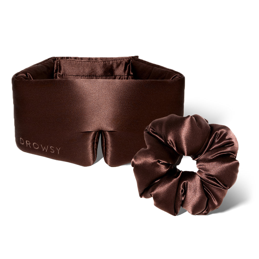 The Silky Skin & Hair Bundle - Cocoa Glow by drowsysleepco, featuring a pure silk sleep mask with "DROWSY" on the side and a matching silk scrunchie, is displayed on a white background.
