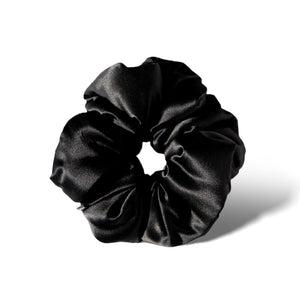 The Black Jade - Padded Scrunchie features a soft, shiny black satin design and is shown against a white background with a subtle shadow—ideal for supporting hair health and enhancing your style.