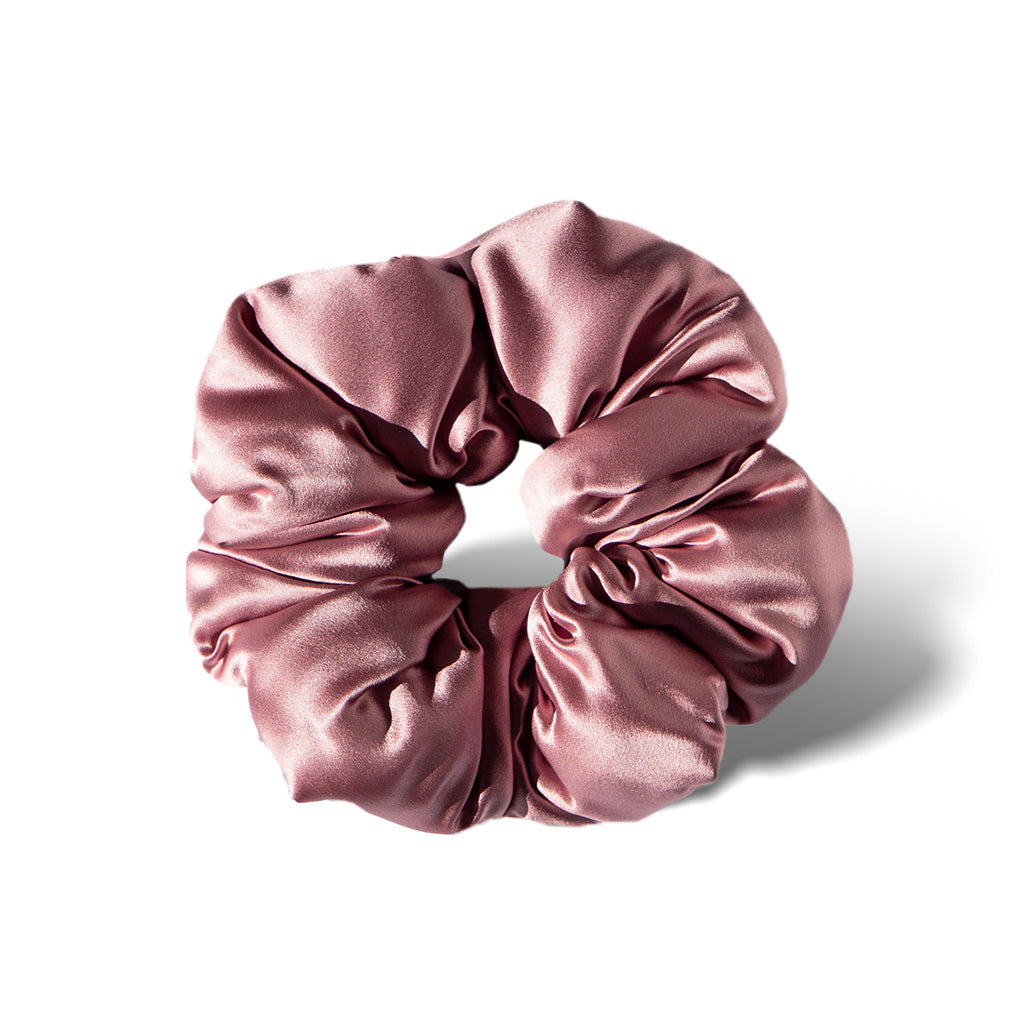 The Damask Rose - Padded Scrunchie is a shiny, pink oversized silk hair accessory with gathered, ruched fabric arranged in a circular shape, shown on a white background for a touch of luxury.