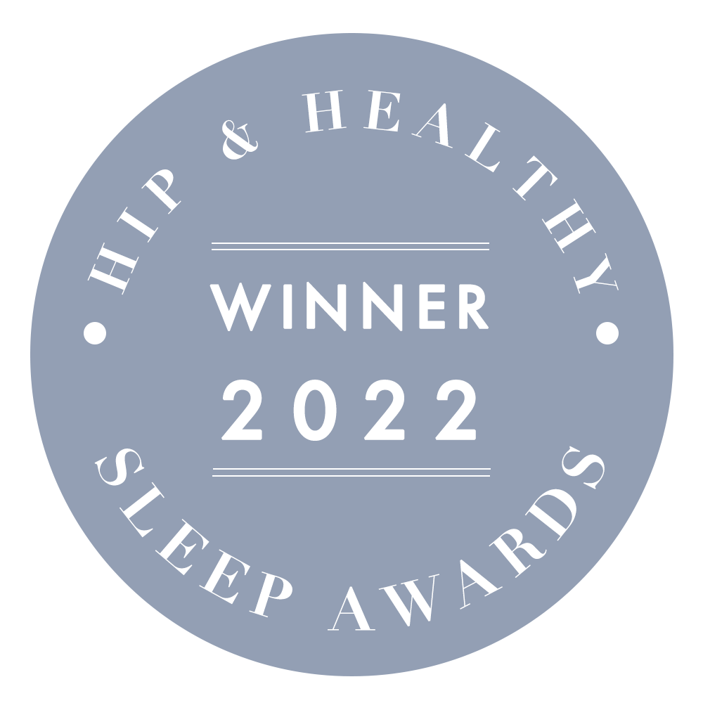 A circular gray badge with the text “Hip & Healthy Sleep Awards Winner 2022” in white capital letters.