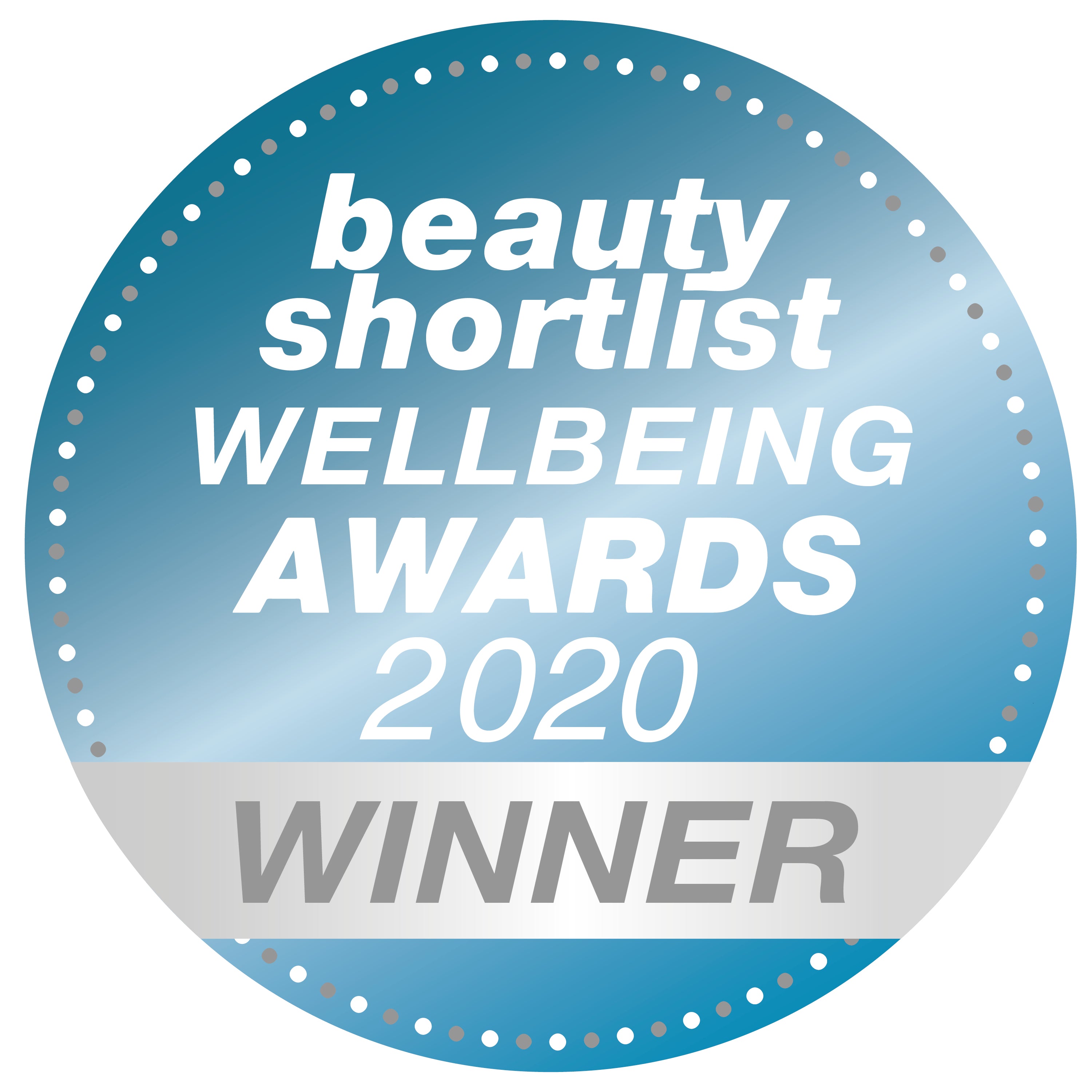 A round blue badge reads beauty shortlist WELLBEING AWARDS 2020 WINNER with WINNER highlighted on a silver ribbon across the bottom. The badge has a dotted border.