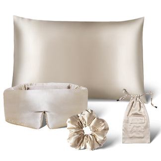 The Sensual Sleep Bundle - Dusty Gold by drowsysleepco features a beige silk pillowcase, sleep mask, scrunchie, and a matching drawstring pouch, all elegantly arranged on a white background.