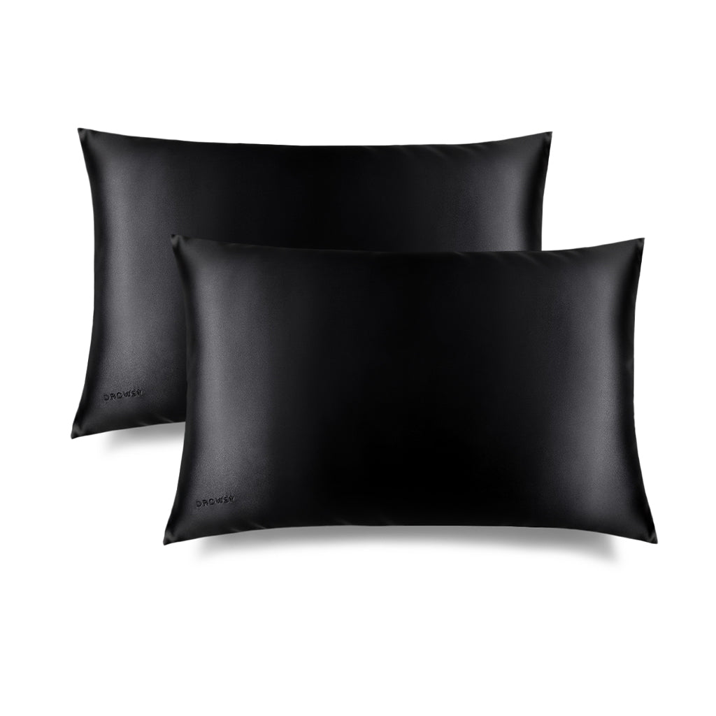 Two Black Jade Silk Pillowcases features a sleek black rectangular design with a subtle embroidered DROWSY logo in the lower left corner, displayed on a white background with a soft right shadow—an essential for hair protection and skincare.