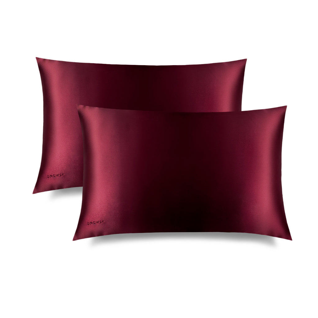 Two La Vie En Rouge Silk Pillowcases, in deep burgundy with a subtle sheen, is rectangular and hair-protecting, featuring "DROWSY" embroidered in one corner, shown against a plain white background.