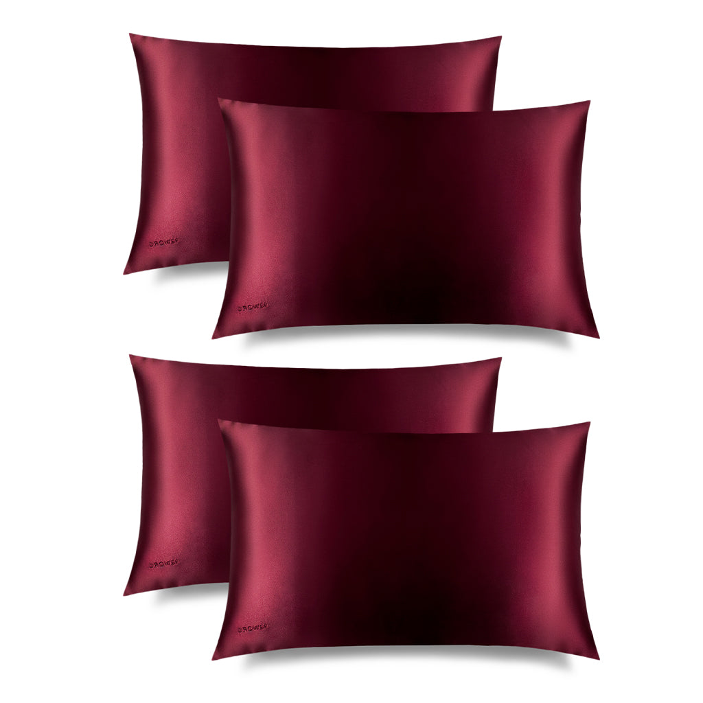 Four La Vie En Rouge Silk Pillowcases, in deep burgundy with a subtle sheen, is rectangular and hair-protecting, featuring "DROWSY" embroidered in one corner, shown against a plain white background.