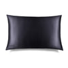 The Moonlight Shadow Silk Pillowcase, rectangular and smooth in black silk with DROWSY embroidered in the lower left corner, is shown on a white background with a subtle right shadow—ideal for skincare and hair protection.