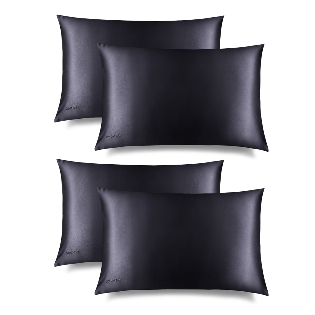 Four Moonlight Shadow Silk Pillowcases, rectangular and smooth in black silk with DROWSY embroidered in the lower left corner, is shown on a white background with a subtle right shadow—ideal for skincare and hair protection.