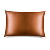 The Pumpkin Spice Silk Pillowcase, in a shiny bronze hue, is displayed on a white background with a “DROWSY” logo in the corner—an essential for skincare and beauty, perfect for protecting your hair.