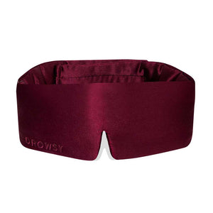 The La Vie En Rouge is a deep burgundy silk blackout sleep mask with a wide, smooth band and DROWSY subtly embossed on the lower left. Designed for beauty sleep, it features a slight notch at the bottom center.