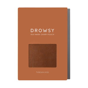 A rectangular orange-brown package labeled PUMPKIN SPICE SILK CARRY POUCH features a window displaying the mulberry silk pouch inside; TUSCAN KISS is printed at the bottom.