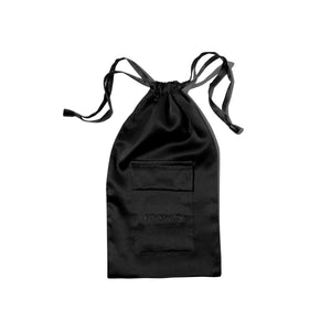The Black Jade Silk Carry Pouch is a black satin drawstring bag featuring a front pocket and “DROWSY” embroidered below it—ideal for storing your silk sleep mask. Displayed on a white background.