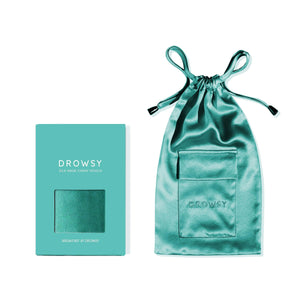 A teal mulberry silk Breakfast at Drowsy Carry Pouch with a drawstring and its matching teal box are displayed side by side against a white background.