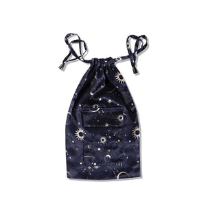 The Cosmic Energy Silk Carry Pouch, in navy blue mulberry silk, features a celestial pattern with stars, moons, and suns in white and light tones—perfect for storing your silk sleep mask. Shown on a plain white background.