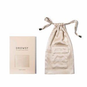 A beige mulberry silk pouch with a drawstring and front pocket is displayed beside its matching rectangular packaging labeled Dusty Gold Silk Carry Pouch.