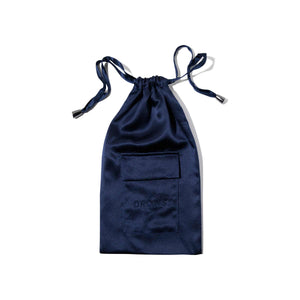 The Midnight Blue Silk Carry Pouch is a navy satin drawstring pouch with a small front pocket and DROWSY embossed, ideal for holding your sleep mask. Shown photographed on a white background.