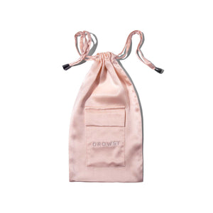 The Sunset Pink Silk Carry Pouch, made from pale pink mulberry silk with DROWSY embroidered on its front pocket, is photographed against a white background.