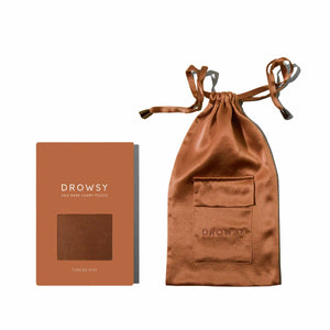 The Pumpkin Spice Silk Carry Pouch comes in warm copper-brown with a matching box. Both feature the DROWSY logo, and the pouch includes a drawstring closure plus pocket—the ideal set for your silk sleep mask.