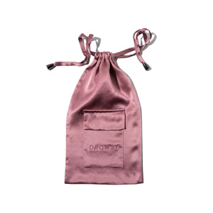 The Damask Rose Silk Carry Pouch in mauve satin features a front pocket and DROWSY embossing, ideal for storing your favorite sleep mask. Shown here on a white background.