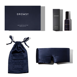 The Midnight Blue - Deep Sleep Collection gift set features a luxury silk sleep mask, matching drawstring pouch, deep sleep pillow spray, a box, and large rectangular packaging, all elegantly arranged on a white background.