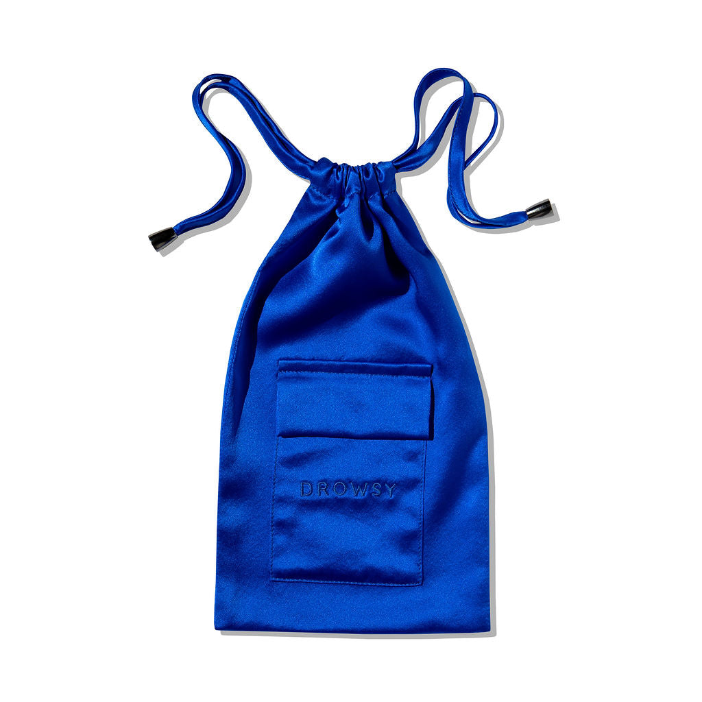 The Royal Blue Silk Carry Pouch features a satin drawstring design, front pocket, and "Drowsy" embroidery—ideal for carrying your silk sleep mask. Shown against a white background.