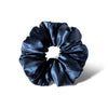 The Midnight Blue - Padded Scrunchie, featuring a shiny, deep blue hue, is shown oversized against a white background with a soft shadow cast to the right.