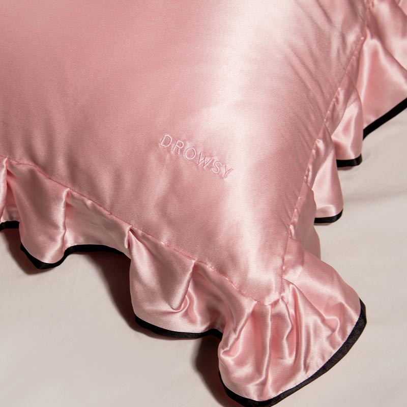 The Sleep and the City - Pink & Black Pillowcase by drowsysleepco, featuring shiny pink satin with ruffled edges and 