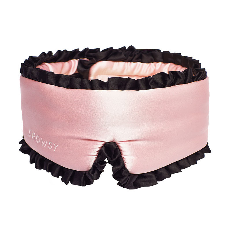 The drowsysleepco Sleep and the City Pink & Black is a thick, padded satin sleep mask with black ruffled edges and “Drowsy” embroidery. It wraps fully around your head for maximum light blocking.