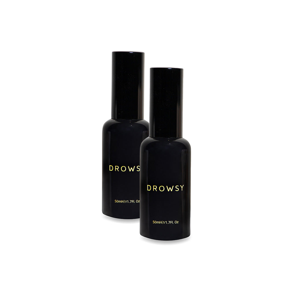 Two black bottles labeled Sleep S.O.S Pillow Spray in gold, each 50ml (1.7 fl oz), stand side by side on a white background—perfect for enhancing your nightly ritual with a natural sleep aid.